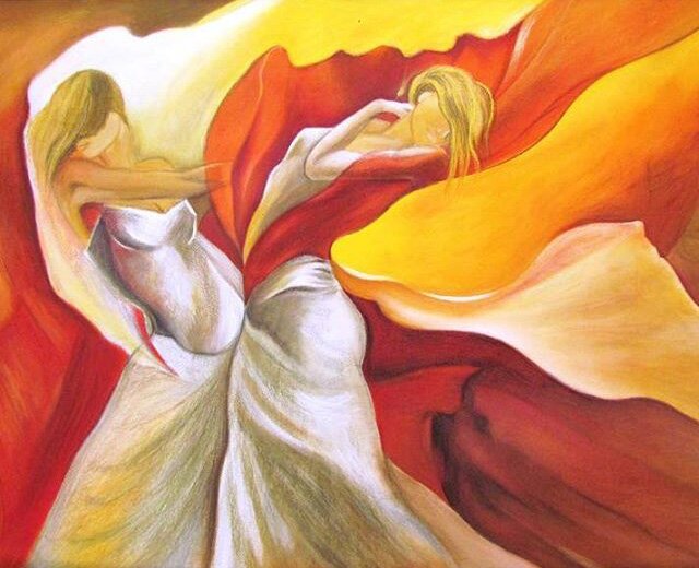 Two dancers turn together, wrapped in flowing silk in flame and sunset colours.